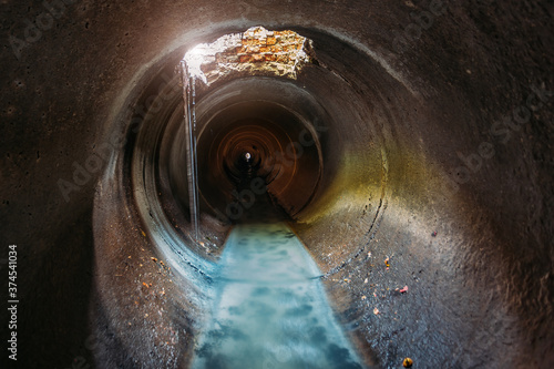 Industrial wastewater and urban sewage flowing through round sewer pipe