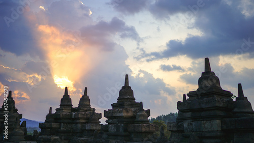 Glorious sunset at Borobudur Temple in East Java, Indonesia. Blue and orange sky over the hills, green jungles and stupa, travel destination, UNESCO World Heritage Site © Lesia Povkh