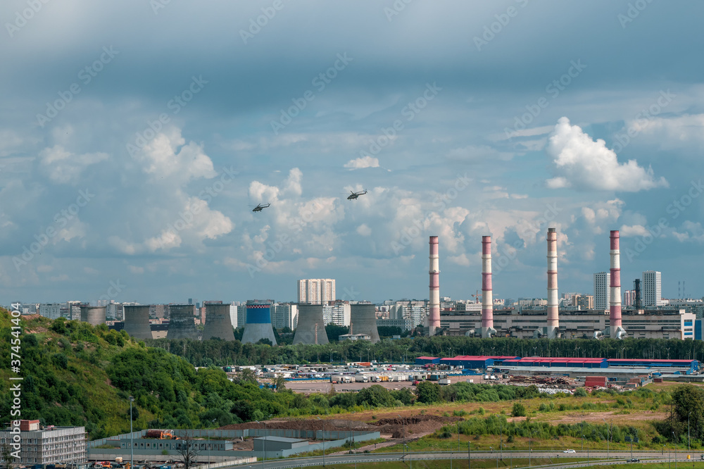 Helicopters over the city. Helicopters fly over an industrial area on the outskirts of Moscow