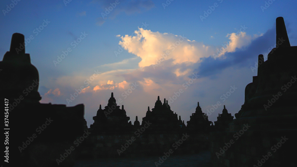 Borobudur Temple in Indonesia, epic cloudy sunset, UNESCO world heritage site, soft focus, film grain, travel concept, spirituality and peace