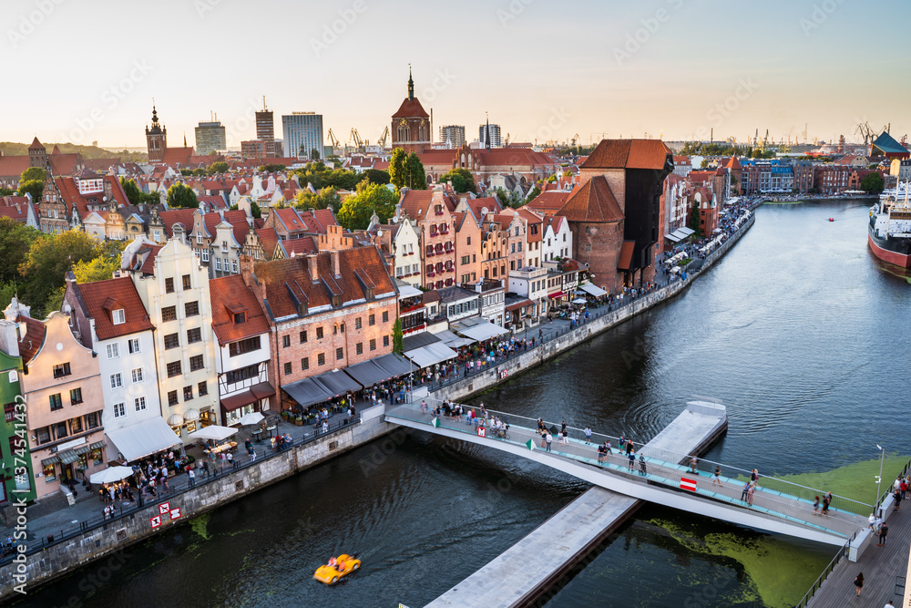 Gdansk, North Poland : Panoramic aerial shot of Motlawa river embankment in Old Town during sunset where people can be seen boating