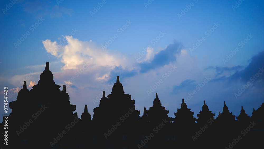 Borobudur Temple in Indonesia, epic cloudy sunset, UNESCO world heritage site, soft focus, film grain, travel concept, spirituality and peace