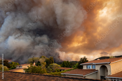 The California "River Fire" of Salinas, in Monterey County, was ignited by dry lightning on August 16, 2020, fills the sky with dark smoke and flames as it burns close to a houses on its first day. 