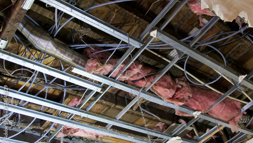 View of interior of ceiling space with ducting, wires and insulation photo