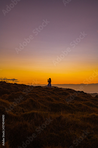 woman on a mountain at sunset