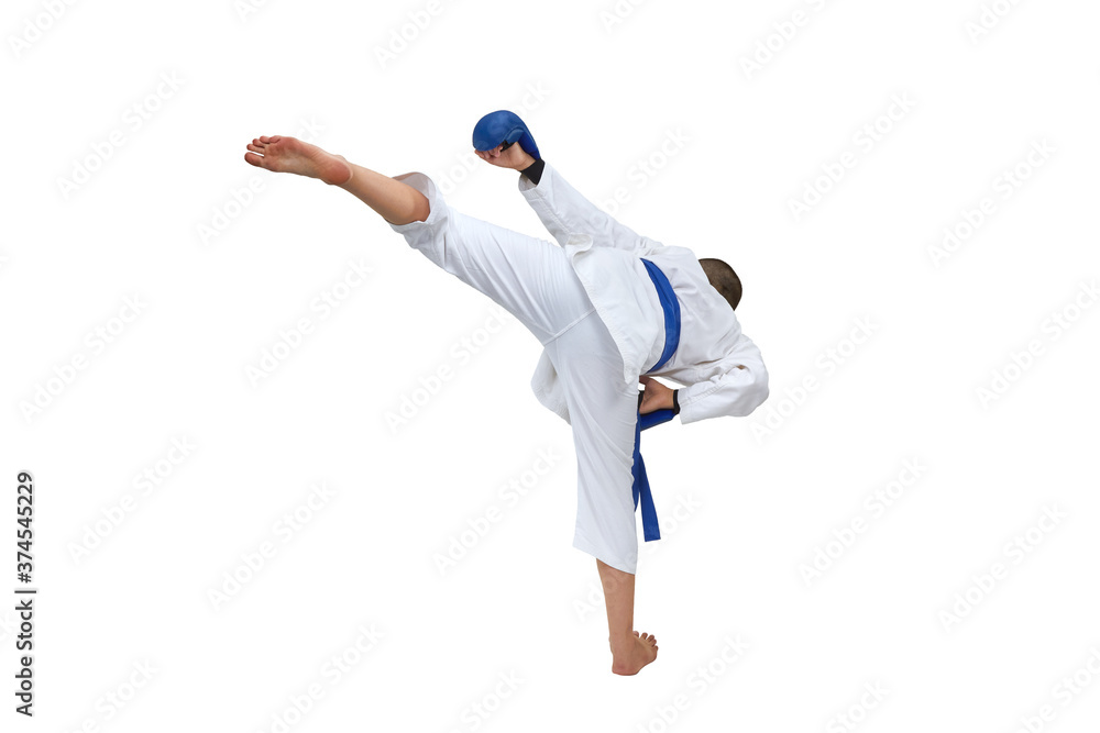 Athlete in karategi with blue belt training leg kick on white isolated background Athlete in karategi with blue belt training leg kick on white isolated background