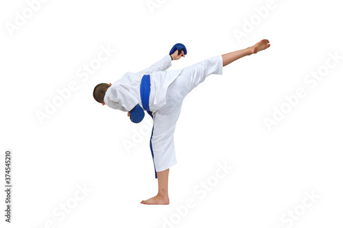 Athlete in karategi with blue belt doing kick on white isolated background