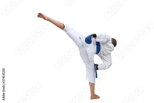 In karategi boy athlete training kick kick on white isolated background