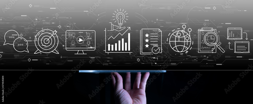 Content marketing concept with woman hand using a digital tablet computer on dark grey backgroiund.