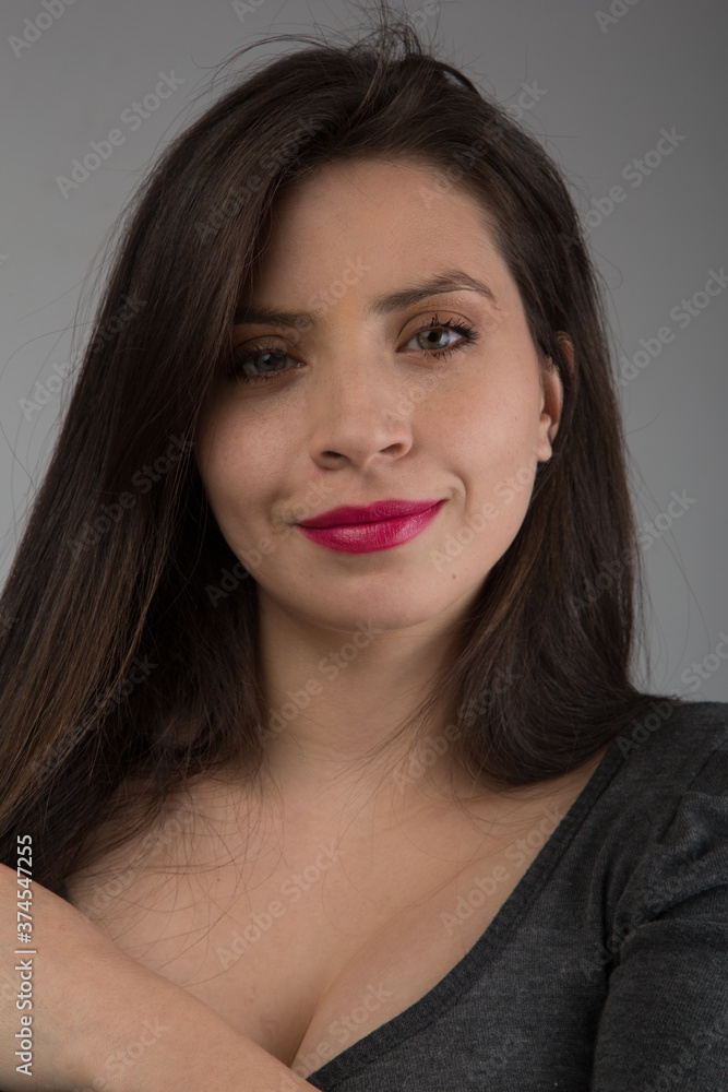 face of young white skinned woman with long straight hair, light eyes and makeup smiling, looking straight ahead, studio shot face of young white skinned woman with long straight hair, light eyes and makeup smiling, looking straight ahead, studio shot