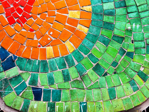 Detail of beautiful old collapsing abstract ceramic mosaic adorned building. Venetian mosaic as decorative background. Selective focus. Abstract Pattern. Abstract mosaic colored ceramic stones photo