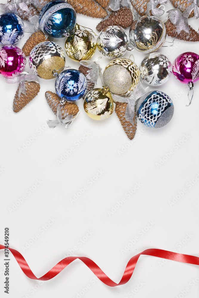 Top view of Xmas tree decorations and pine cones. Vertical stock photo of decorative Christmas ornaments on white background with copy space Top view of Xmas tree decorations and pine cones. Vertical stock photo of decorative Christmas ornaments on white background with copy space