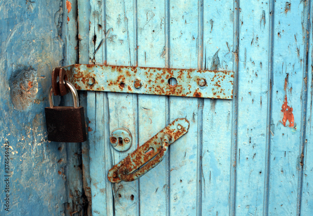 old rusty lock on a wooden door old rusty lock on a wooden door
