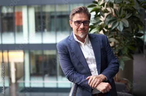 Portrait of elegant mature white man wearing glasses.