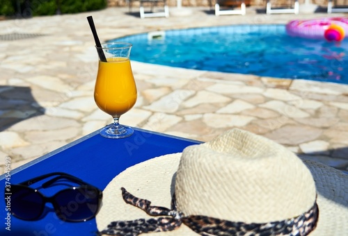 Orange cocktail on poolside outdoor in summer photo