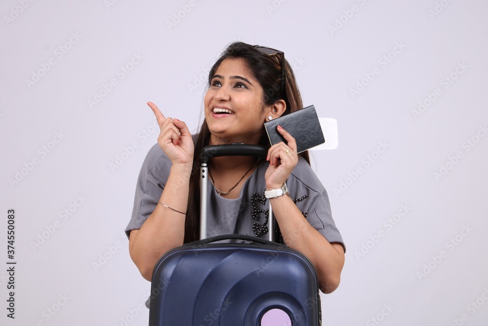 Beautiful smiling young Indian woman tourist holding passport and boarding pass isolated on white background. Beautiful smiling young Indian woman tourist holding passport and boarding pass isolated on white background.