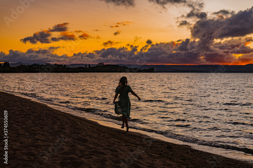 woman on a beach at sunset