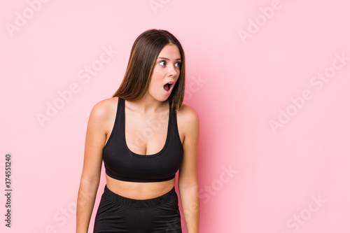 Young fitness caucasian woman isolated being shocked because of something she has seen. © Asier