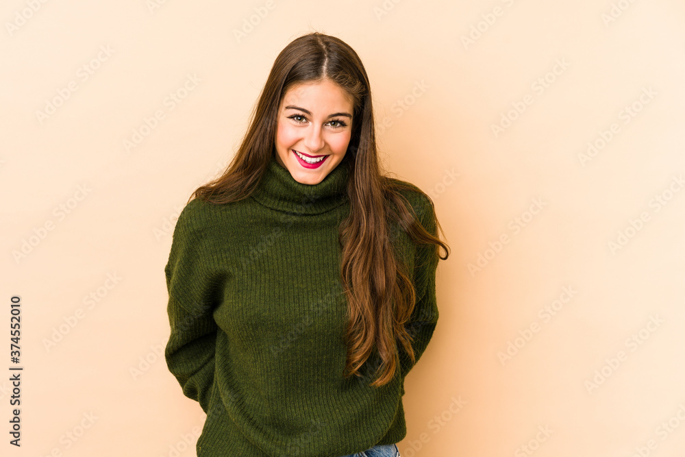 Young caucasian woman isolated en beige background happy, smiling and cheerful. Young caucasian woman isolated en beige background happy, smiling and cheerful.