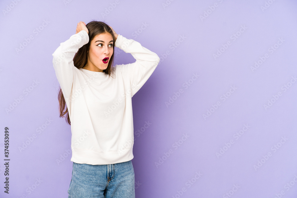 Young caucasian woman isolated on purple background screaming, very excited, passionate, satisfied with something. Young caucasian woman isolated on purple background screaming, very excited, passionate, satisfied with something.