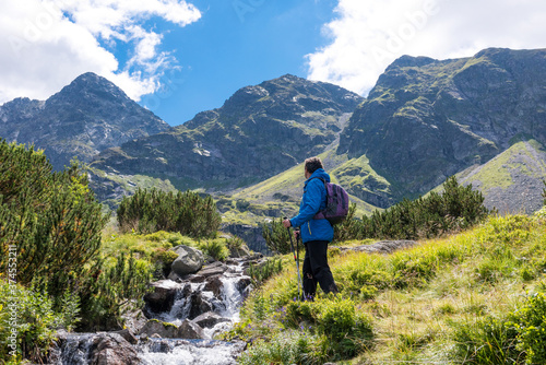 Sporty hiker near summer spring in Tatra Mountains national park, Zakopane, Poland