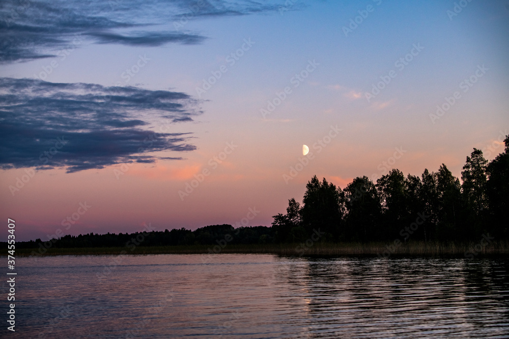 ancient churches on the island at sunset on the background of the lake