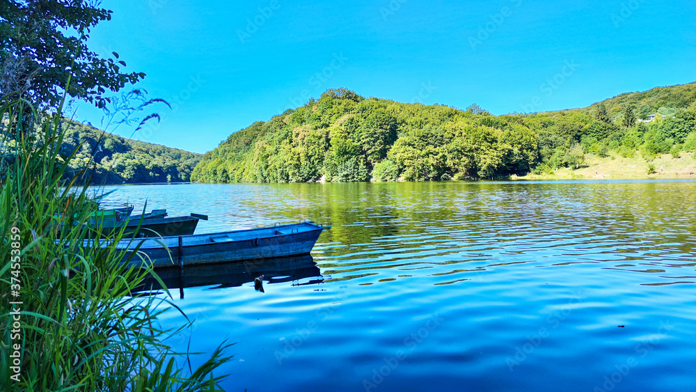 Fototapeta premium Boat station with lake on background in the summer season