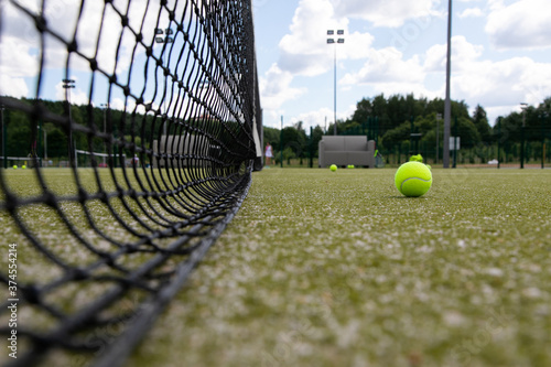 tennis court, tennis racket and tennis balls in the basket