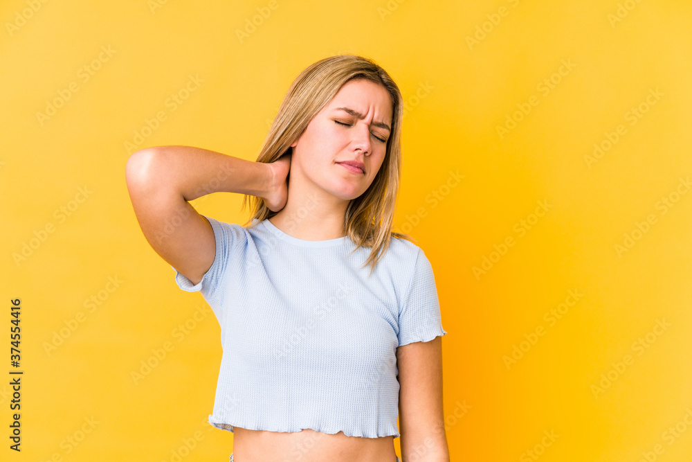 Young blonde caucasian woman isolated suffering neck pain due to sedentary lifestyle. Young blonde caucasian woman isolated suffering neck pain due to sedentary lifestyle.