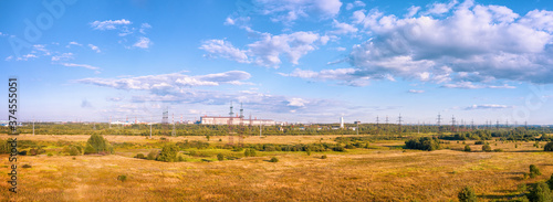 Panoramic landscape with fields, industrial zone and high voltage power line
