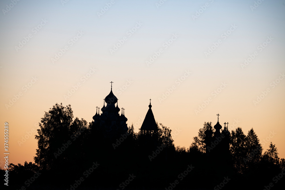 vintage churches on the island at sunrise on the background of the lake