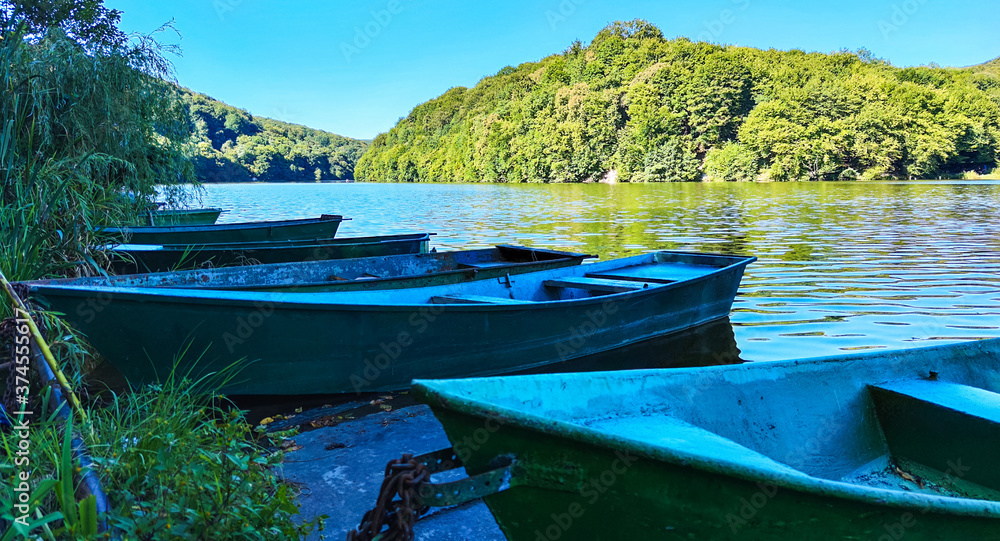 Boat station with lake on background in the summer season Boat station with lake on background in the summer season