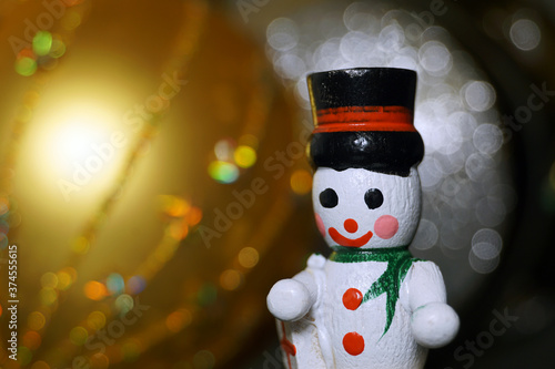No-name christmas toy for decorating christmas tree. Little toy snowman in a minimalist style. The background is blurred.