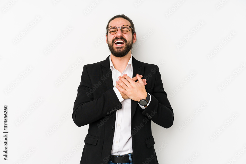 Young caucasian business man isolated on a white background laughing keeping hands on heart, concept of happiness. Young caucasian business man isolated on a white background laughing keeping hands on heart, concept of happiness.