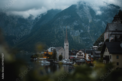 Panorama view of the cute old town located at the Hallstätter Lake on a moody dark rainy day with clouds in the mountains. Hallstatt, Austrian Alps, Salzkammergut in Austria, Europe