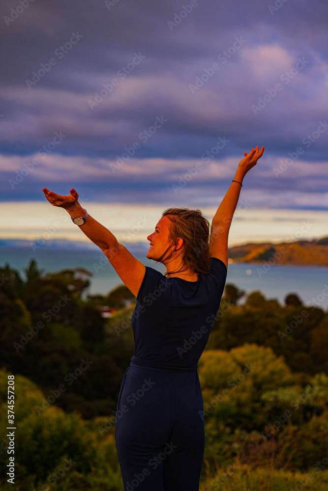 woman doing yoga exercises at sunset
