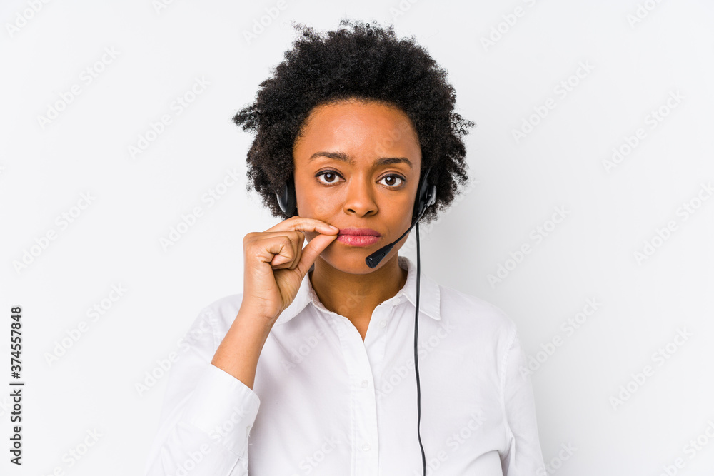 Young african american telemarketer woman isolated with fingers on lips keeping a secret.
