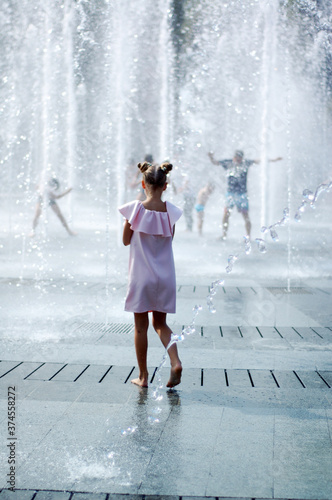Summer. Dry Fountain. The girl bathes in the fountain.