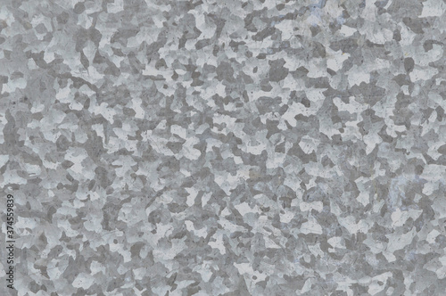 metal grunge background: sheet of rolled metal with scratches and stains, dirt. Toning, close