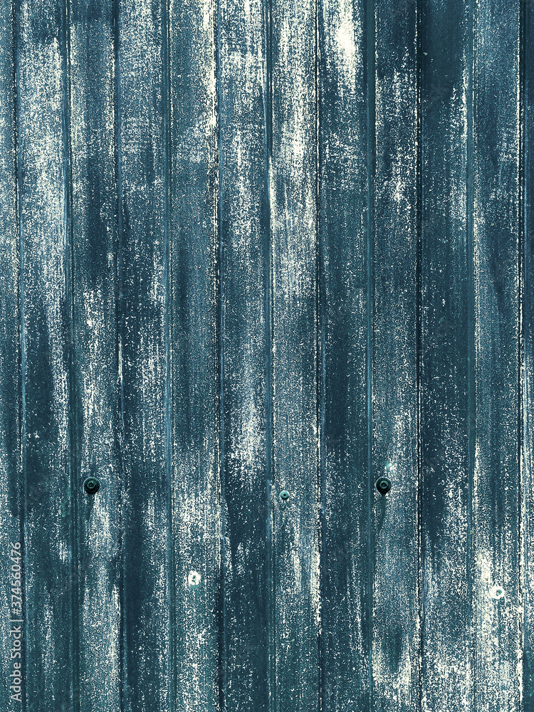 Traces and colored spots of paint on a rusty metal sheet.