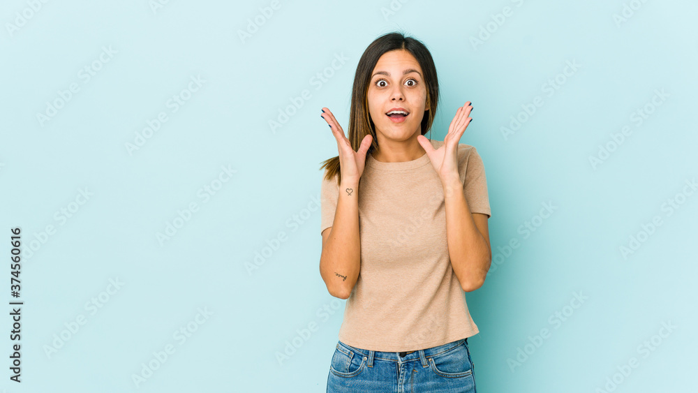 Young woman isolated on blue background surprised and shocked. Young woman isolated on blue background surprised and shocked.