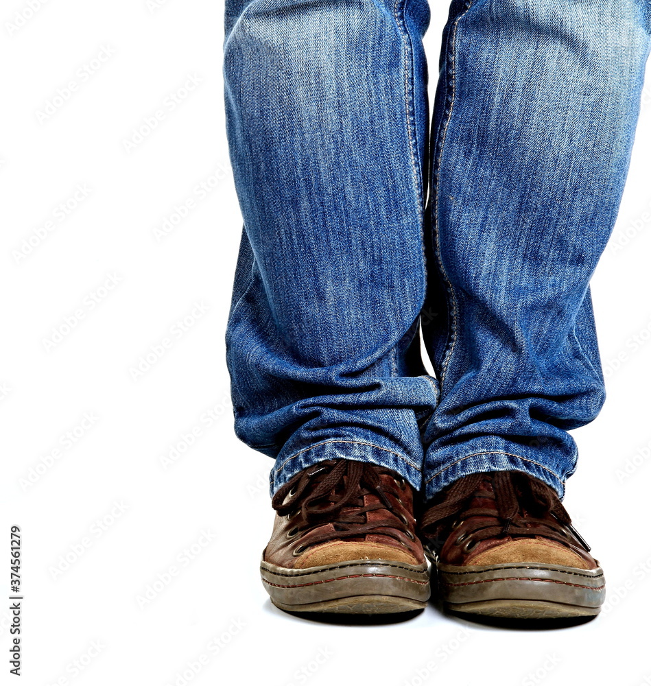 man standing with shoes and blue jeans on white background