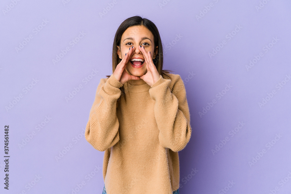 Young woman isolated on purple background saying a gossip, pointing to side reporting something. Young woman isolated on purple background saying a gossip, pointing to side reporting something.
