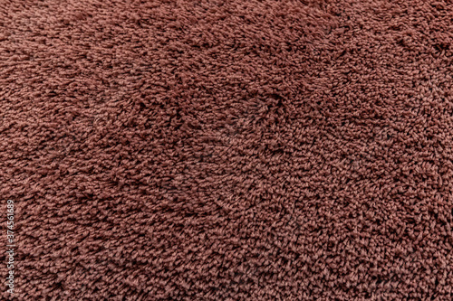 The texture of a brown carpet. Fleecy surface. Background