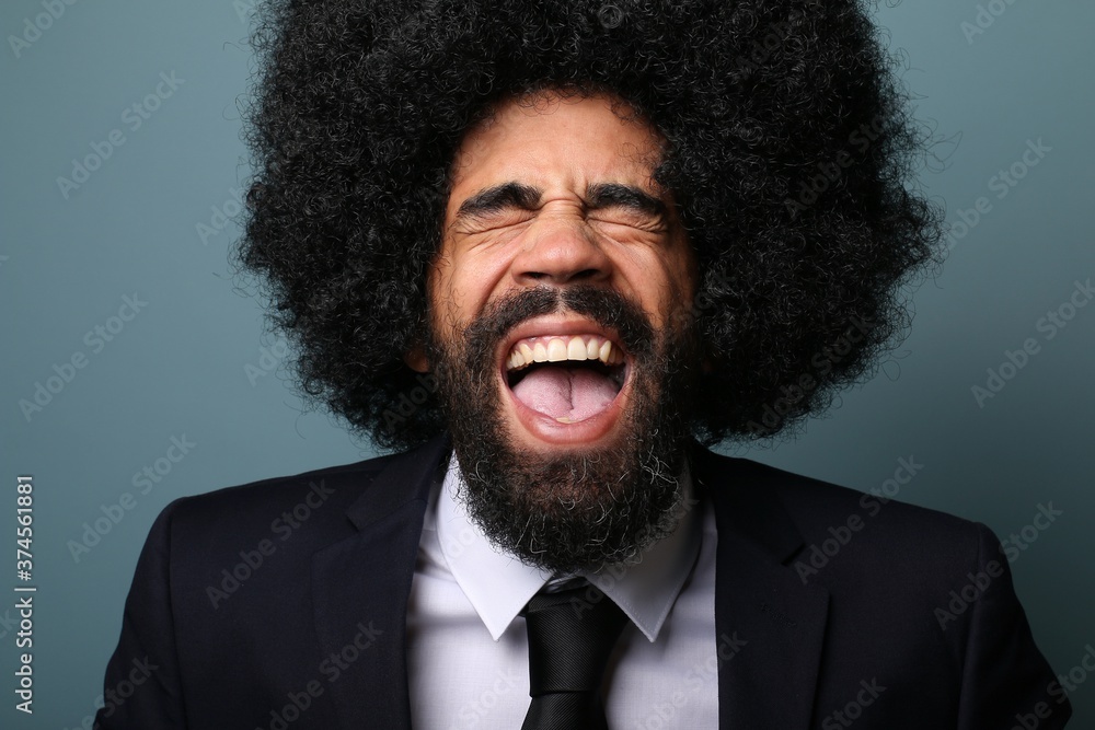 Beautiful afro man in front of a colored background Beautiful afro man in front of a colored background