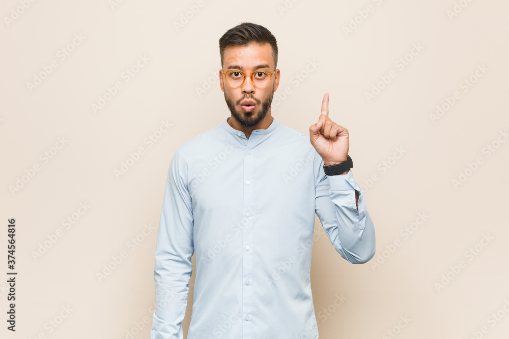 Young south-asian business man having some great idea, concept of creativity. Young south-asian business man having some great idea, concept of creativity.