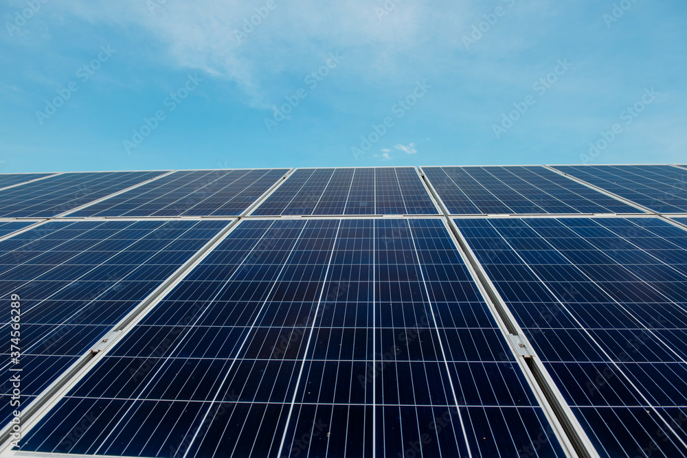 Photovoltaic power plant. Solar photovoltaic panels on blue sky background Photovoltaic power plant. Solar photovoltaic panels on blue sky background