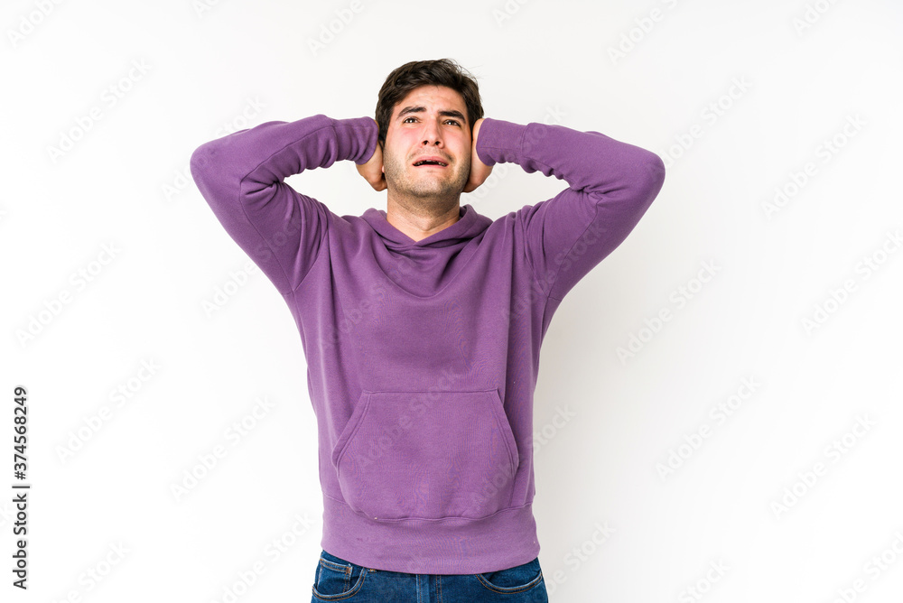Young man isolated on white background screaming with rage. Young man isolated on white background screaming with rage.