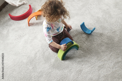 Child Assembling Wooden Rainbow Toy