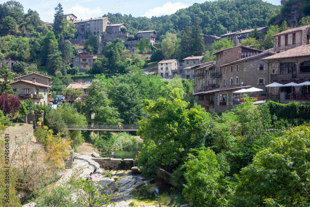 Suspension bridge over a mountain river in a Spanish village.